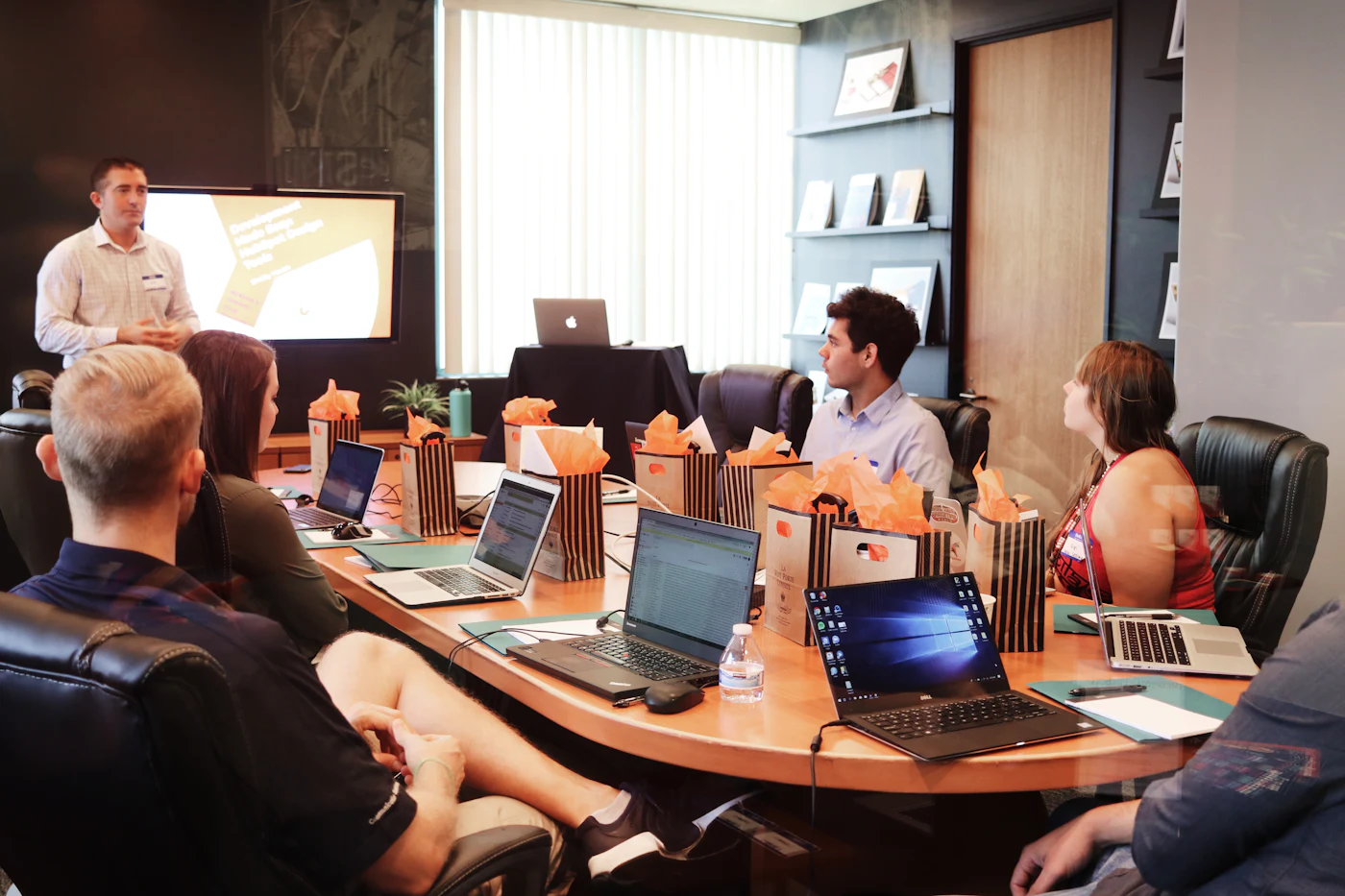 A leadership team reviewing a presentation in a meeting room